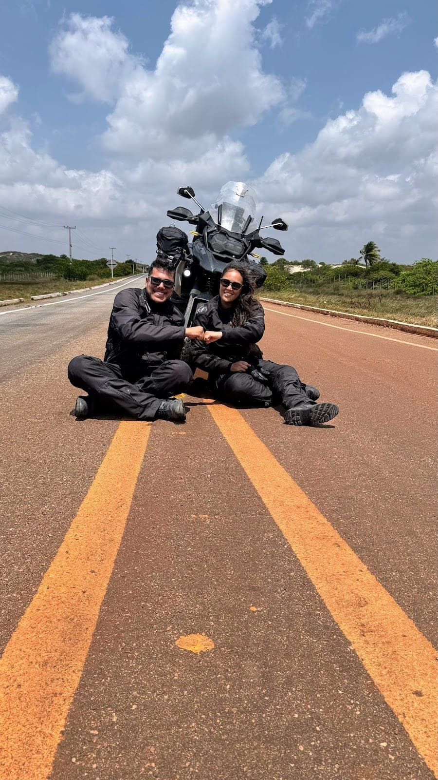 Sentados no meio da estrada com a moto atrás